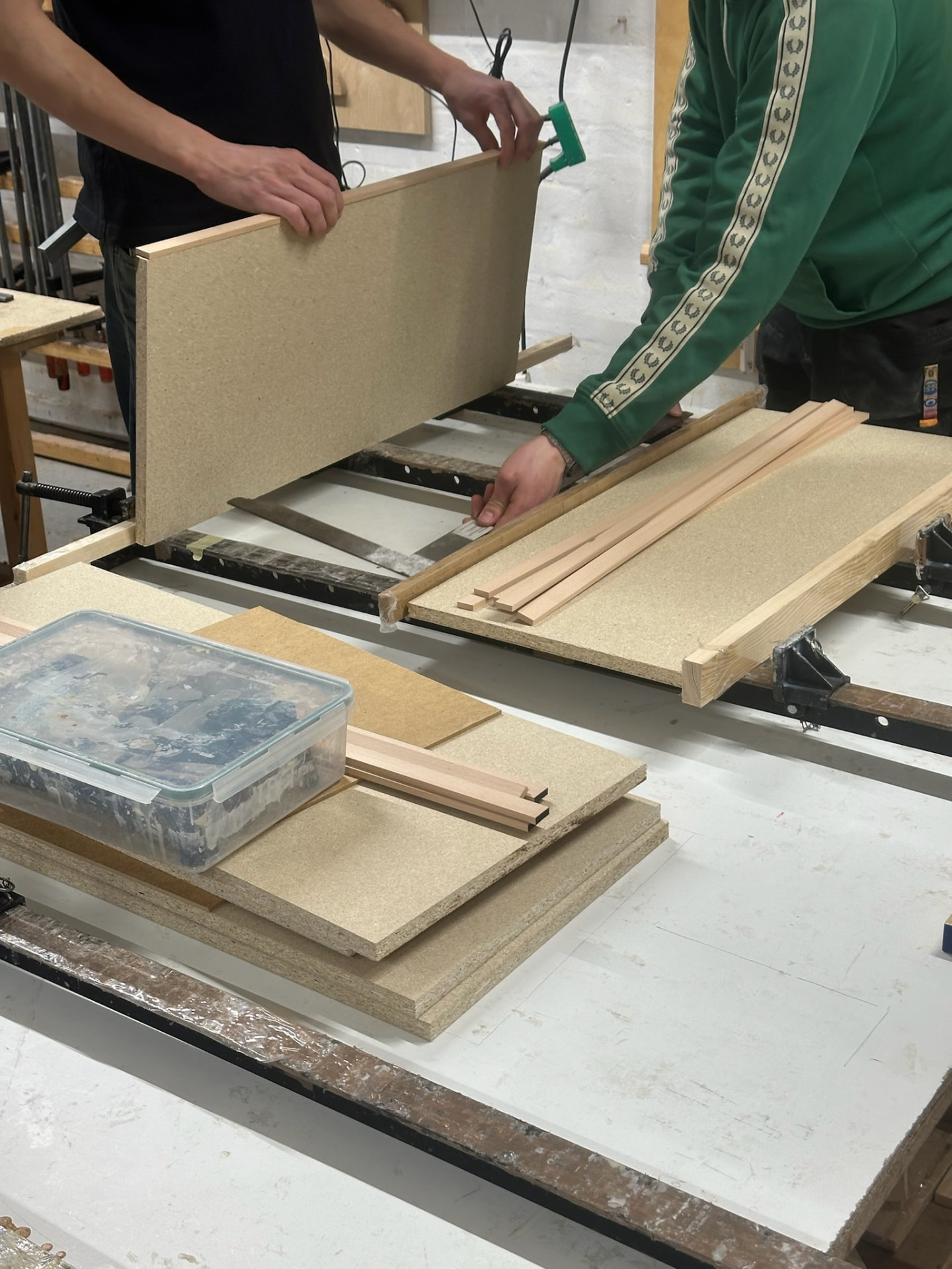 Chipboard caul and battens being prepared for pressing veneer.