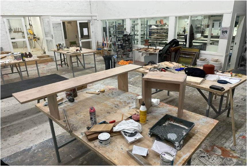 Workshop at Krabbesholm with a bench and stool in progress on trestle tables.